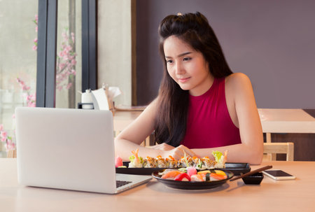 girl with laptop in japan restaurant