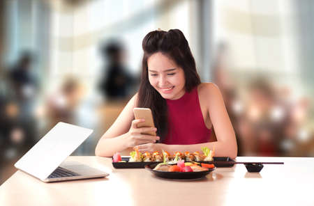 girl with moblie in japan restaurantの写真素材