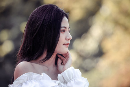 One women in Public park drink coffee and read a book relaxed at bangkok city thailandの写真素材