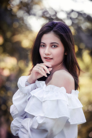 One women in Public park drink coffee and read a book relaxed at bangkok city thailandの写真素材