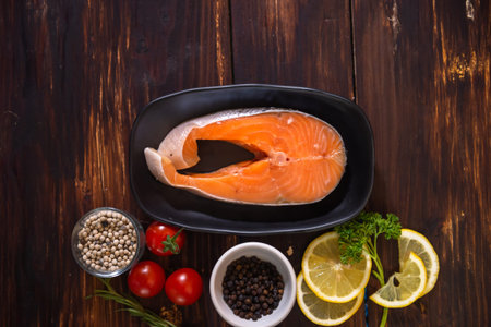 Raw uncooked salmon steak, popular Japanese cuisine placed on the table with side dishes