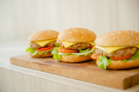 Popular fast food hamburgers placed on the table and served with a drink.