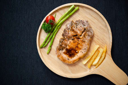 The pork steak is cooked and served on the table.の写真素材