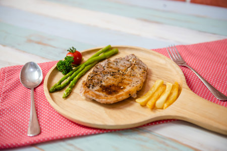 The pork steak is cooked and served on the table.