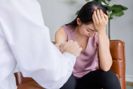 Doctor Psychiatrist concept, The doctor held the patient's hand to comfort save Female Patients in the office. の写真素材