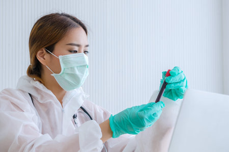 A female doctor is working with notebook in the office of a blood test hospital, a patient infected