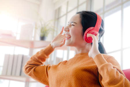 beautiful teen students studying and working at home From the pandemic of the Coronavirus, Girls enjoy listening to music at homeの写真素材
