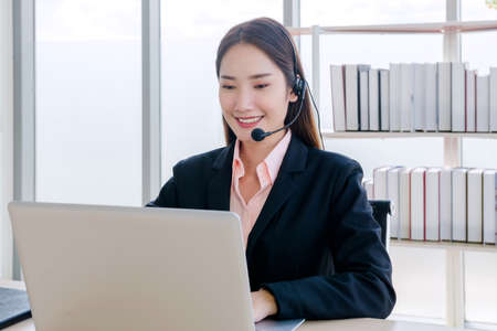 beautiful teen students studying and working at home From the pandemic of the Coronavirus, Covid-19, caused the new normal worldwide. for social distancing, she Is using a notebook computerの写真素材
