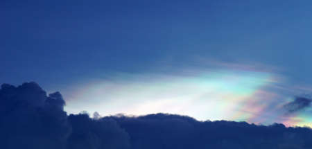 Blue sky with clouds under evening sun auraの写真素材