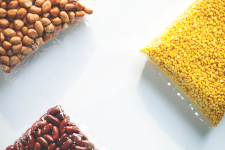 Soybeans, peanuts that are being placed on a white backgroundの写真素材