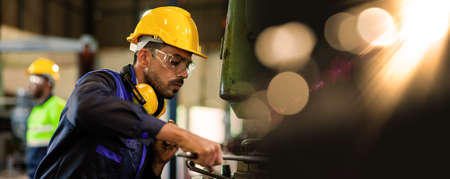 An expert male engineer or worker is working in an industrial plant. Workers work confidently.の写真素材