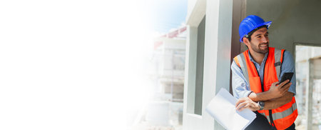 Portrait of a handsome engineering consultant on a construction site holding a blueprint in his...