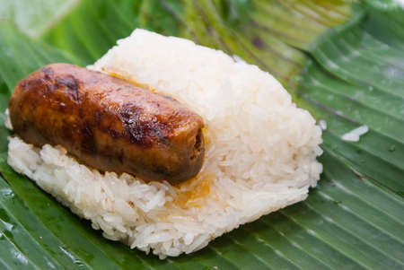 Sticky rice with thai sausage. Covered with banana leaf. Thai street foodの写真素材