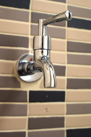 metal tap with water drop