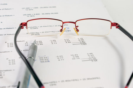 eyeglasses and pencil on documentの写真素材