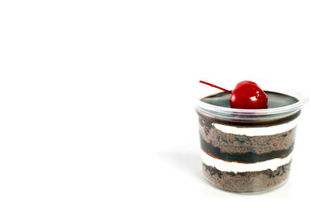 Chocolate cup cake and cherry on white backgroundの写真素材