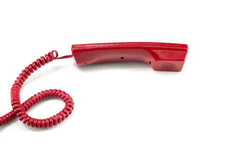 Red telephone receiver isolated on a whiteの写真素材