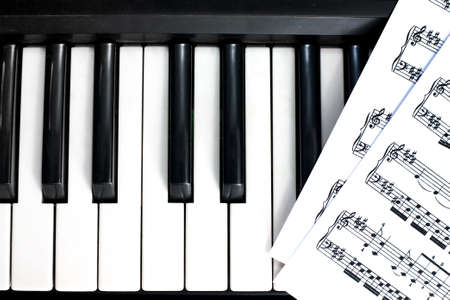 background of piano keyboard with notesの写真素材