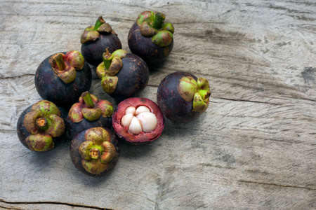 Fresh mangosteen fruit on woodの写真素材
