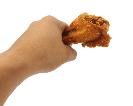 Hand hold fried chicken isolated on whiteの写真素材