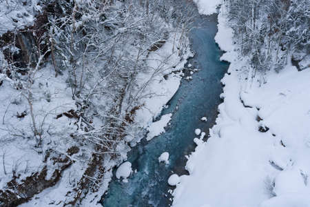shirahige waterfall located 600 meters above sea leven in the Shirogane hot spring village of Biei City, this waterfall stands more than 30 meters tall. The water flowing down the gaps between the rocks resembles a white beard.の写真素材