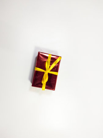 Birthday sparkling gift box in red and yellow, isolated white backgroundの写真素材