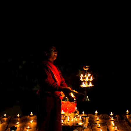 Varanasi, India - 25th December 2015 : Young boy performing rituals during Ganga Aarti.のeditorial素材