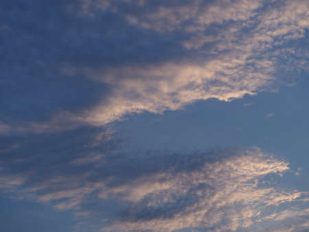 the sun shines on the white cloudの写真素材