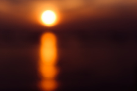 blur background landscape of sea sunset and boatの写真素材