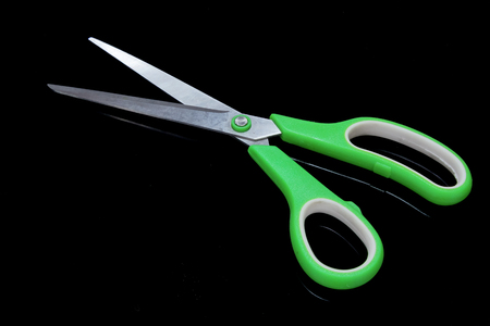 Green Scissor on black backgroundの写真素材