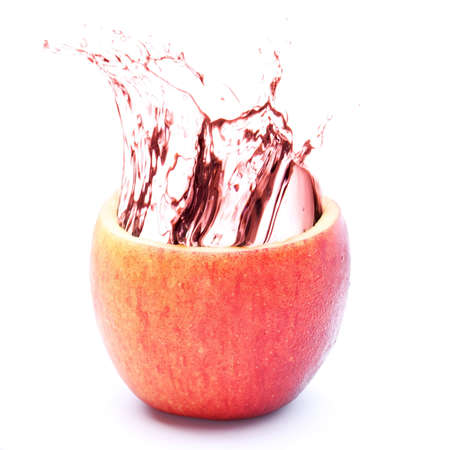 Apple juice splashing isolated on whiteの写真素材