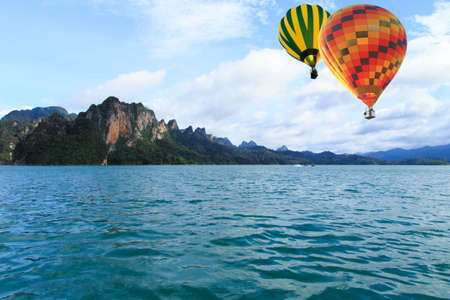 Colorful hot-air balloons flying over the mountainの写真素材