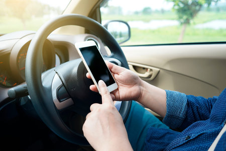 A man using a smart phone in a car, road trip, travel, destination technology and people concept.