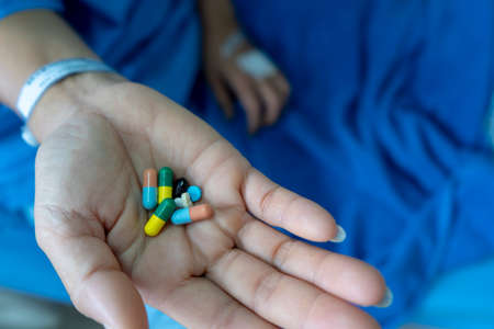 Blue dress woman on hospital bed Have medicine on handの写真素材