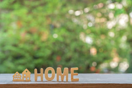 Wooden letters Is a home message With green background, financial conceptの写真素材