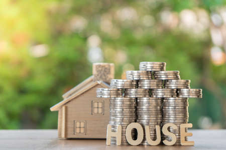 Set money Coin, shaped like a house ,house model, and house text. With green background, financial conceptの写真素材