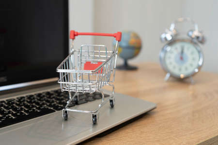 Online shopping concept. Shopping cart, on laptopの写真素材