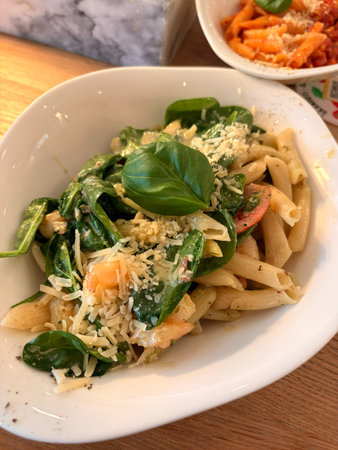 Delicious Penne Pasta with Shrimp, Spinach, and Parmesanの写真素材