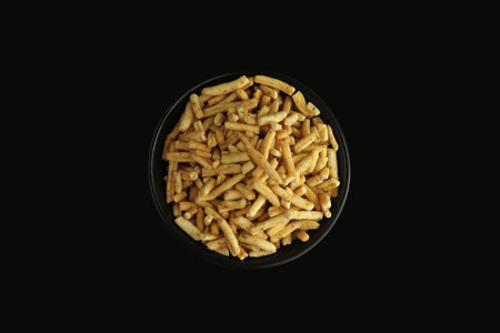 Sev (Indian Snack) in black bowl on black backgroundの写真素材