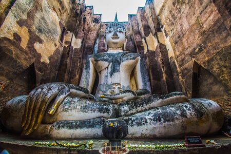 Sukhothai Historical Park  Thailand  traveller with ancient Buddha statue at Wat Si Chum temple.の写真素材