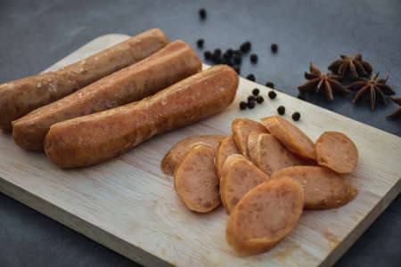 Sausage Or Guan Chiang and Herbs on the board, serving good beer snacks on a dark background.の写真素材