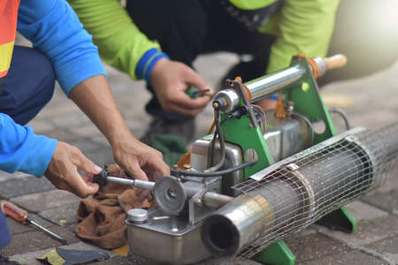 The mechanic is repairing the machine - spraying mosquitoes to prepare for mosquito spray.の写真素材