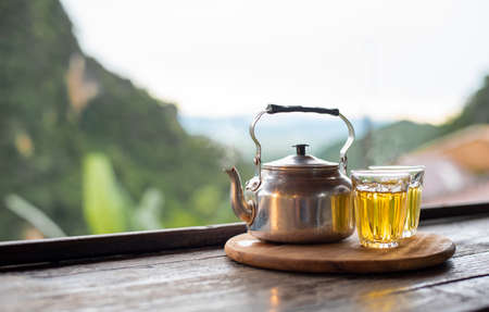 Cup of tea and teapot on table,natural backgroundの写真素材