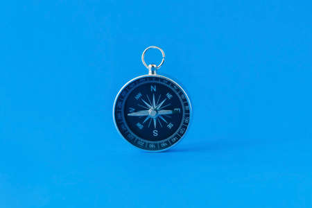 compass isolated on blue background life goal concept compass pointing the wayの写真素材