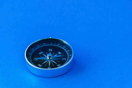 compass isolated on blue background life goal concept compass pointing the wayの写真素材