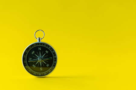 compass isolated on yellow background life goal concept compass pointing the wayの写真素材
