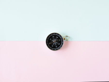 Compass isolated on blue and pink background, life goal concept. compass pointing the wayの写真素材