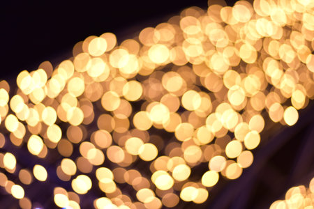Abstract golden bokeh dark backgroundの写真素材