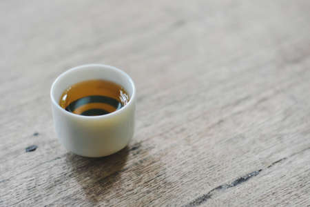 Cup of tea on a wooden table in a coffee shopの写真素材