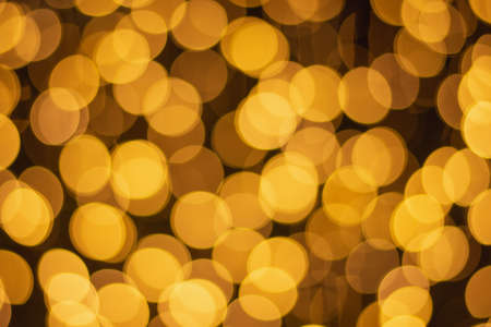 Golden and multicolored bokeh circle background for christmas and happy new year with space to display messagesの写真素材